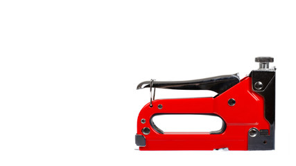 Red industrial stapler, furniture industry hardware. Isolated on white.