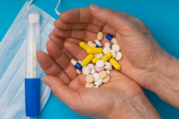 Woman hand with pills medicine tablets and capsule. Coronavirus, flu, medications, seasonal diseases. Medicine and healthcare.