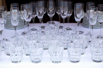 Glasses of champagne at a party or wedding celebration. The waiter pours champagne close-up.