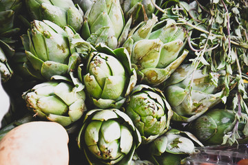 Obraz premium Fresh stacked artichokes and herbs.