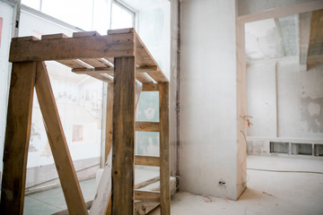 Interior construction of warehouse concrete wall and scaffolding.