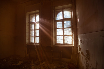 Old dirty window with web and sun rays.