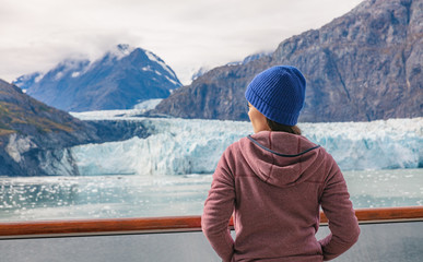 Alaska cruise inside passage to Glacier bay National Park woman tourist relaxing on deck watching...