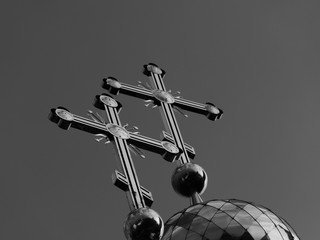 Christian cross above the golden dome of a old church
