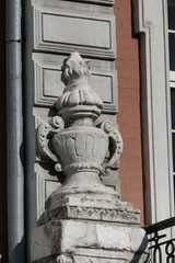 Bas-relief of an amphora, jug or cup on the wall of an old historical building in eastern europe