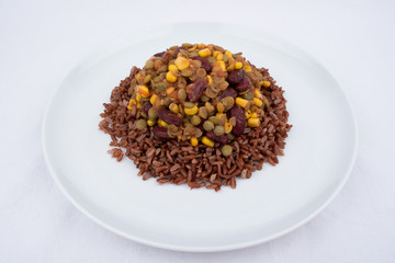 A Vegan Meal With Red Rice, Green Lentisl, Corn and Beans