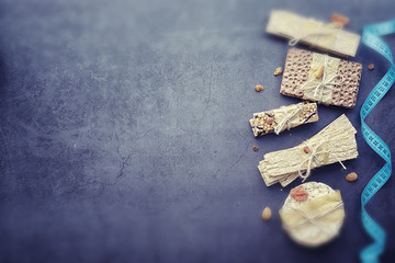Tilt shift effect.Concept of losing weight and a healthy lifestyle. Bread roll with vegetables and herbs on table.Proper nutrition.Dry bread rolls diet.
