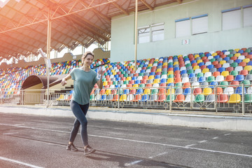 Woman in sportswear doing morning run on the stadium
