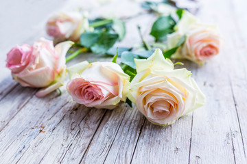 Bouquet of roses on wooden table.