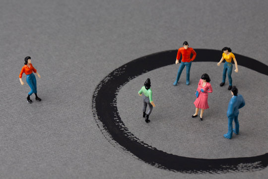 miniature woman outside and people in circles