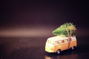 Christmas tree on toy car. Toy car with Christmas tree. Christmas holiday celebration concept