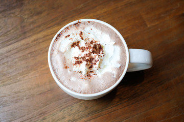 Take a break with hot chocolate cocoa with whipped cream on wooden table in the morning