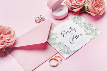 Beautiful composition with wedding invitation and jewelry on color background