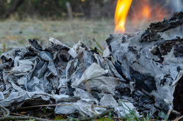 Burning documents close-up. Specially Destroyed by fire documents outdoors. The concept of...