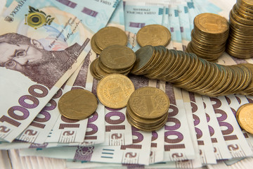 gold coins lie on banknotes. UAH. Ukrainian money