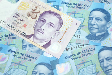 Fototapeta premium A close up image of a two dollar bill from Singapore close up in macro with Mexican twenty peso bank notes