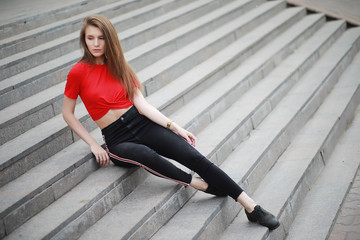 A girl posing on the steps of a building