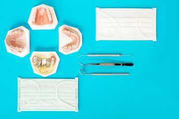  Removable partial denture (RPD.) on blue background, flat lay, top vipw.