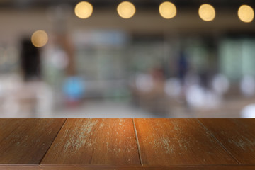 Empty dark wooden table in front of abstract blurred bokeh background of restaurant . can be used for display or montage your products.Mock up for space.