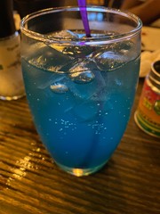 glass of water with ice and lemon on black background