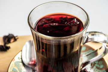 Hot tea isolated on white, hibiscus tea, place for text.