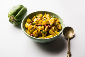 Kaccha Papita Sabji or Raw Papaya Sabzi, served in a karahi or bowl. selective focus