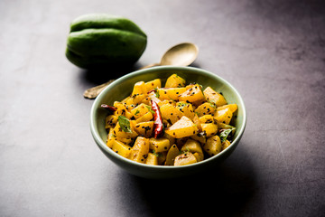 Kaccha Papita Sabji or Raw Papaya Sabzi, served in a karahi or bowl. selective focus