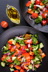 Bright vegetarian salad on a black background