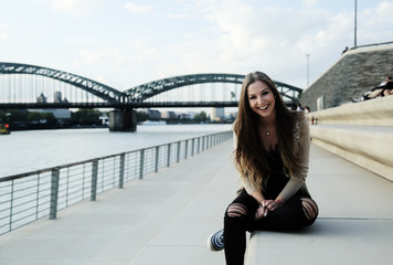 Beautiful stylish woman sitting on street stairs  on summer day