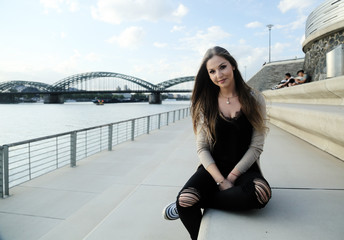 Fototapeta premium Beautiful stylish woman sitting on street stairs on summer day