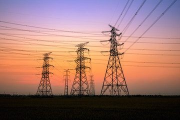 High voltage power tower and beautiful nature landscape at sunset