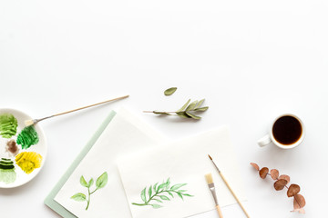 Painting herbs. Brushes and picture on white background top-down copy space