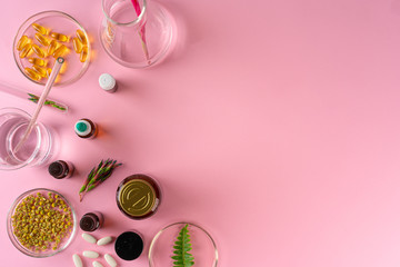 Herbs and Herbal dietary supplements top view on pink background
