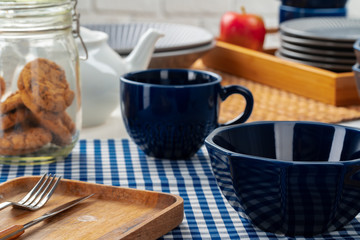 Empty blue ceramic bowl on kitchen table close up