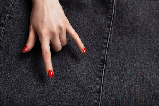 A woman hand with a red manicure showing rock and roll. Background with place for text.