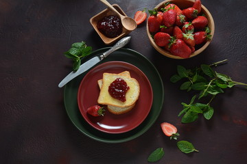 Obraz na płótnie Canvas Toasts with strawberry jam for breakfast, rustic style 