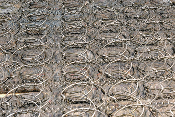 Background of old mattress springs, grey bed texture close-up