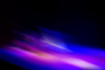 Abstract blurred color blurred dark background, purple, cyan, black and light spots.