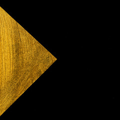 Golden triangle on a black background.
