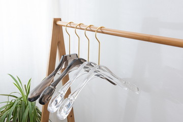 Exquisite clothes hangers of different shapes on wooden supports
