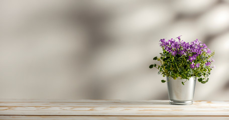 Spring flowers on a wooden table with free space for an advertising product