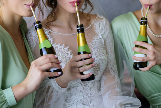 Hands Holding The Mini Bottles Of Champagne. Wedding Party