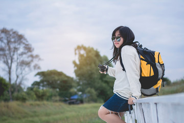 Fototapeta premium Asian women traveling alone with backpack and camera.Travel Holiday Relaxation Concept , Vintage Style.