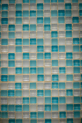 Light blue and white ceramic mosaic on the wall as background
