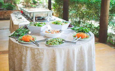 salad table with arugula, cucumber and carrot 