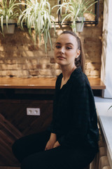 Close up portrait of young fashionable girl in stylish cafe. Youth, new generation, lifestyle concept