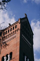 Fototapeta premium Red Catholic Church against the blue sky in Minsk