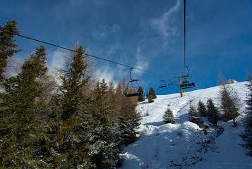 riding on a ski lift over forest
