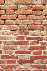 Red cracked brick wall background, texture of ancient brickwork