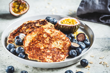 Oatmeal pancakes with honey, fruits and berries. Healthy vegan food concept.